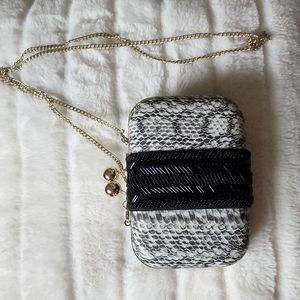 A snake print after hours Clutch style purse.